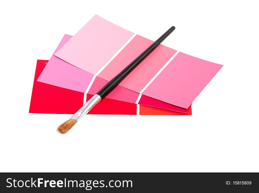 Pink color samples and a brush isolated over white