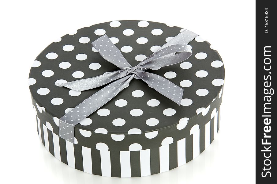 A grey white striped dotted round giftbox isolated over white. A grey white striped dotted round giftbox isolated over white