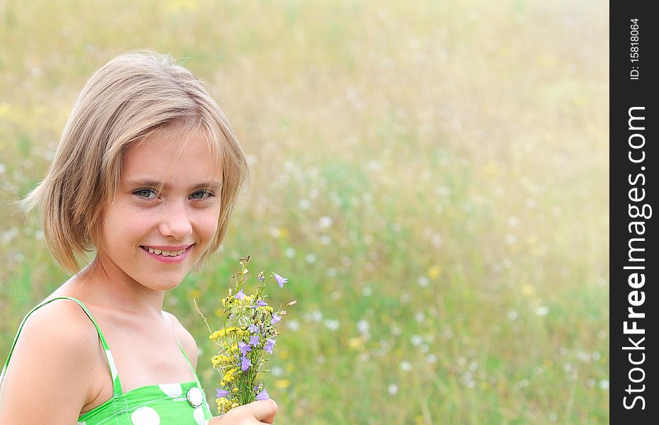 Girl on green field with a bunch of flowers. Girl on green field with a bunch of flowers