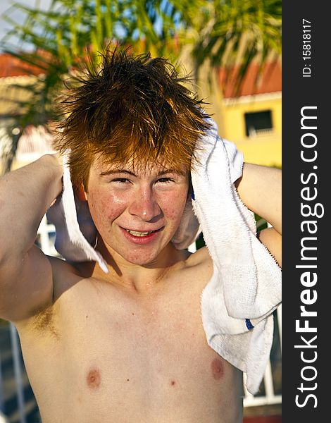 Boy using a towel after swimming in a pool