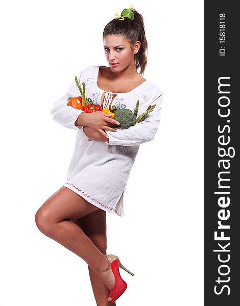 Young beautiful woman with fresh vegetables in her hands. Young beautiful woman with fresh vegetables in her hands