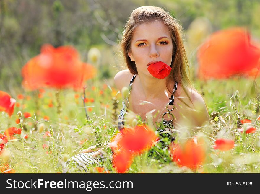Beautiful woman in dress on the   poppy field. Beautiful woman in dress on the   poppy field