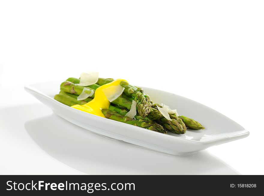 Steamed asparagus topped with hollandaise sauce and parmesan. Steamed asparagus topped with hollandaise sauce and parmesan