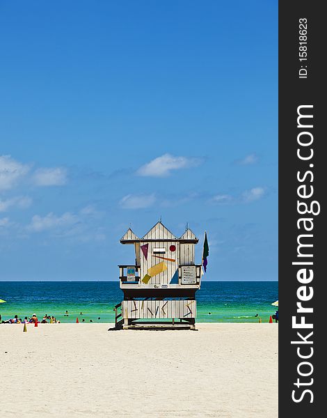 Sunny Miami beach with people enjoying the ocean