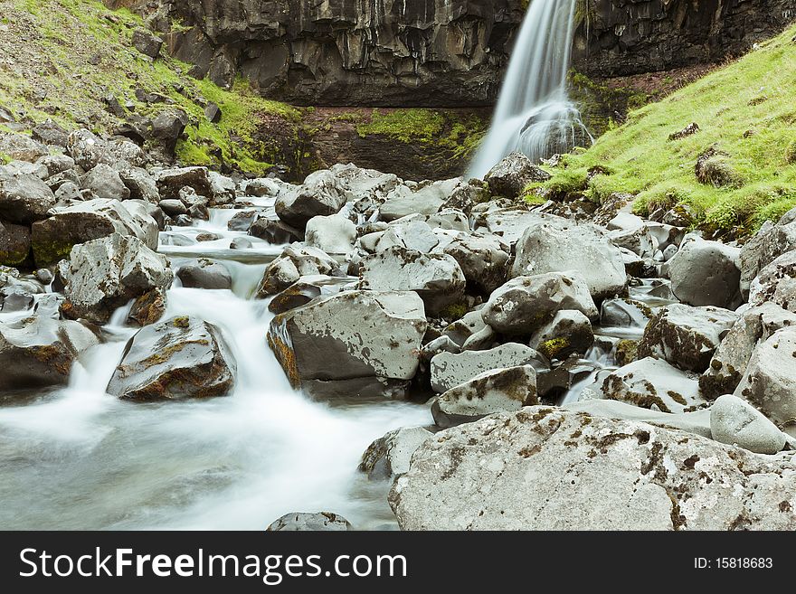 Motion blurred image of a beautiful waterfall in a river gorge in Iceland