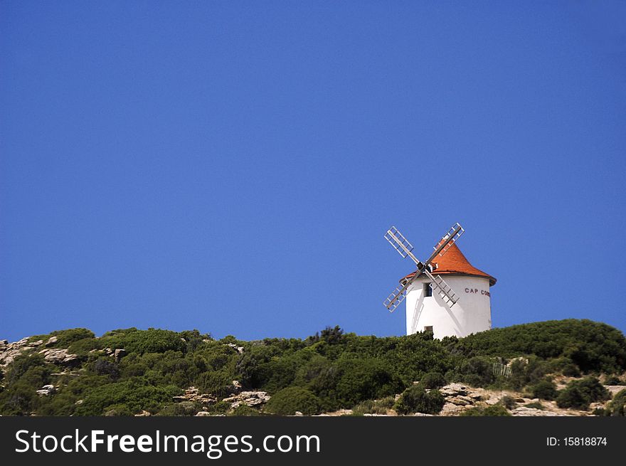 Windmill on a bushed mountain