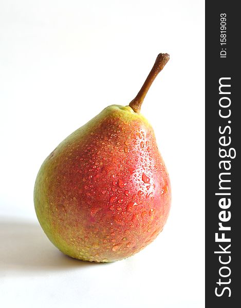 One pear with a red side on a white background