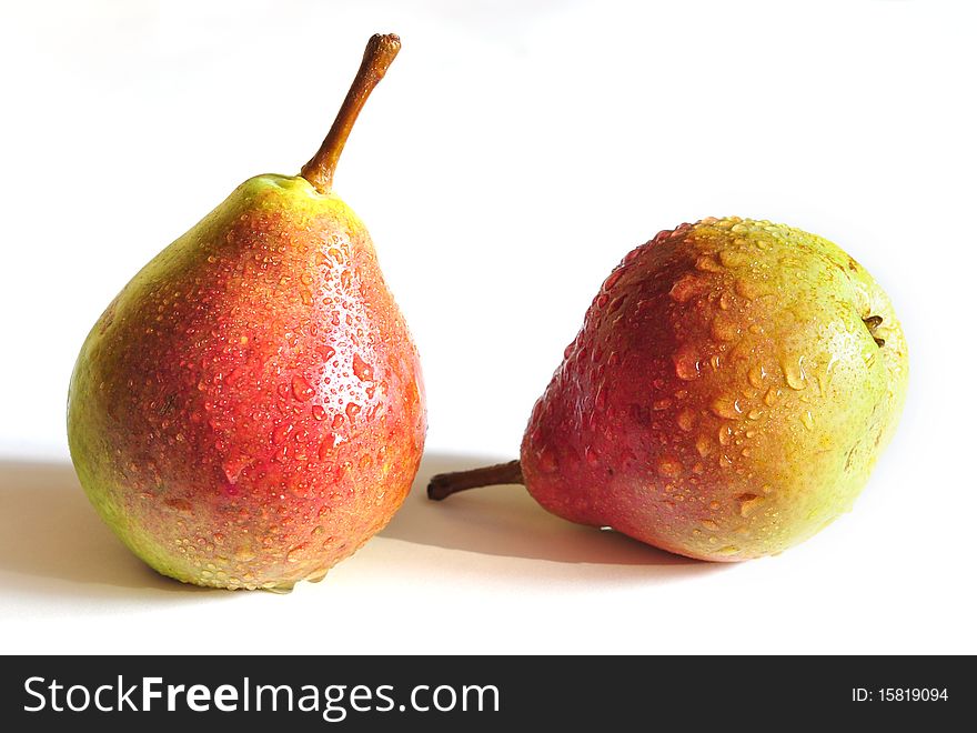 Two pears with a red side on a white background