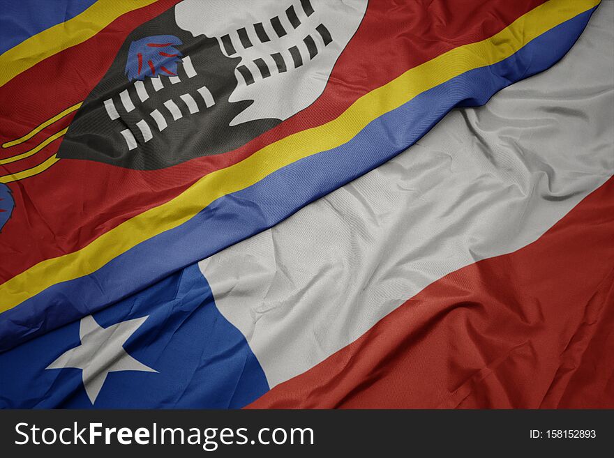 waving colorful flag of chile and national flag of swaziland. macro