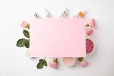 Composition With Rose Essential Oil And Blank Card On White Background, Top View. Royalty Free Stock Photography