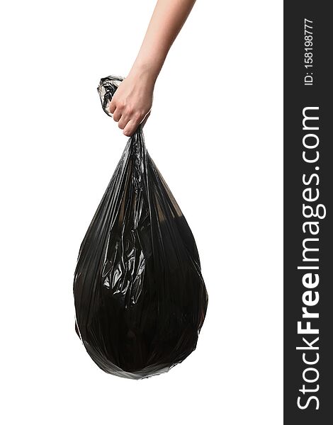 Woman holding bin bag full of garbage on white background. Recycling concept