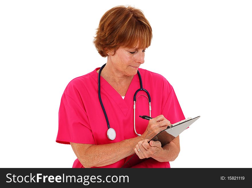 Nurse In Her 50's Writing On Clipboard. Nurse In Her 50's Writing On Clipboard