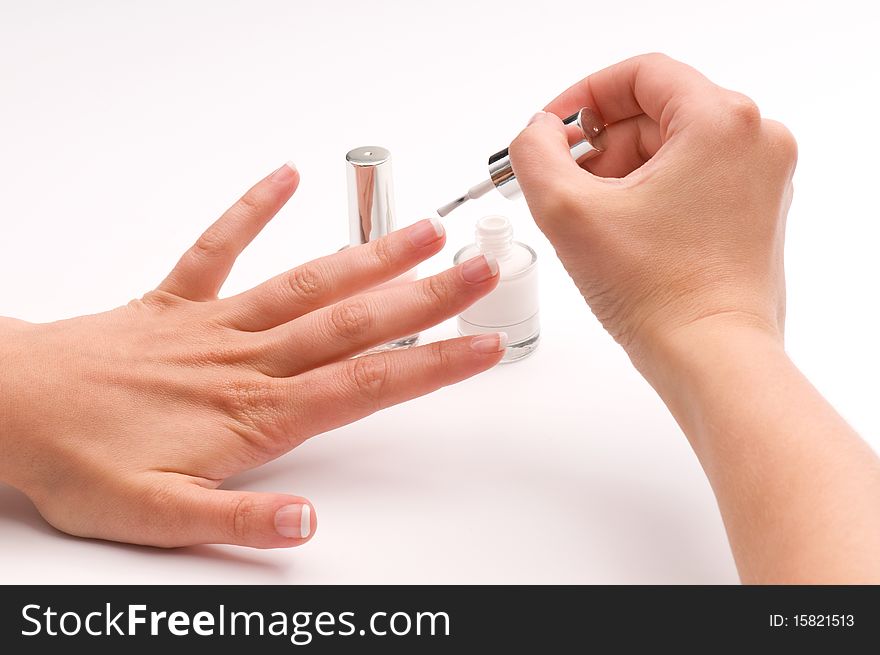 Woman covering her nails with nail polish