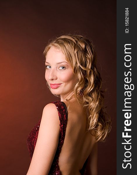 A portrait of beautiful young woman is in a studio