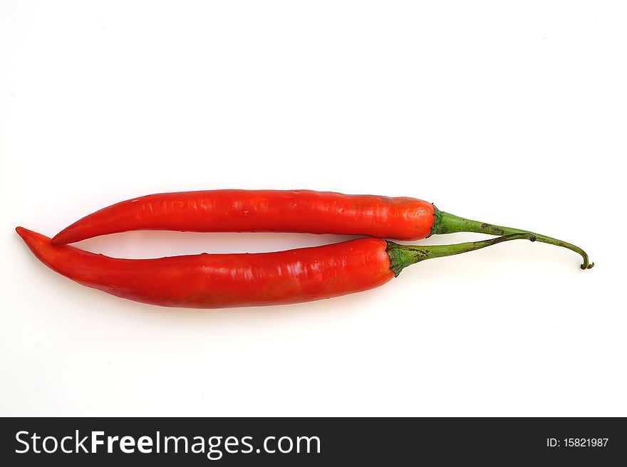 Red hot chili peppers in white background.