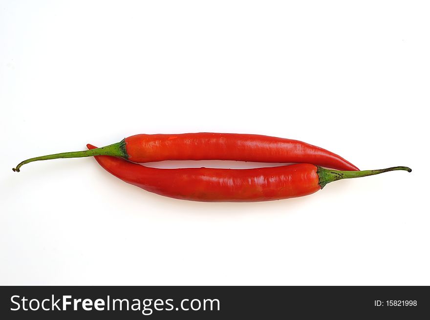 Red hot chili peppers in white background.