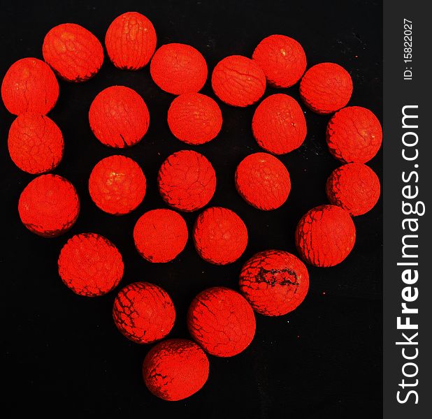 A background of a blood red heart prepared out of red textured balls. A background of a blood red heart prepared out of red textured balls