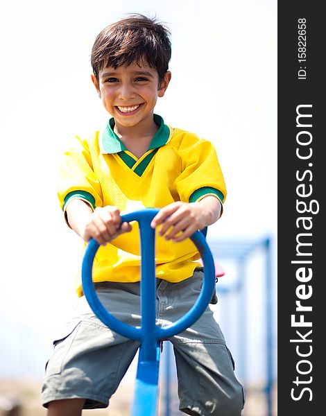 Boy in soccer uniform playing in the park and taking ride on swing. Boy in soccer uniform playing in the park and taking ride on swing