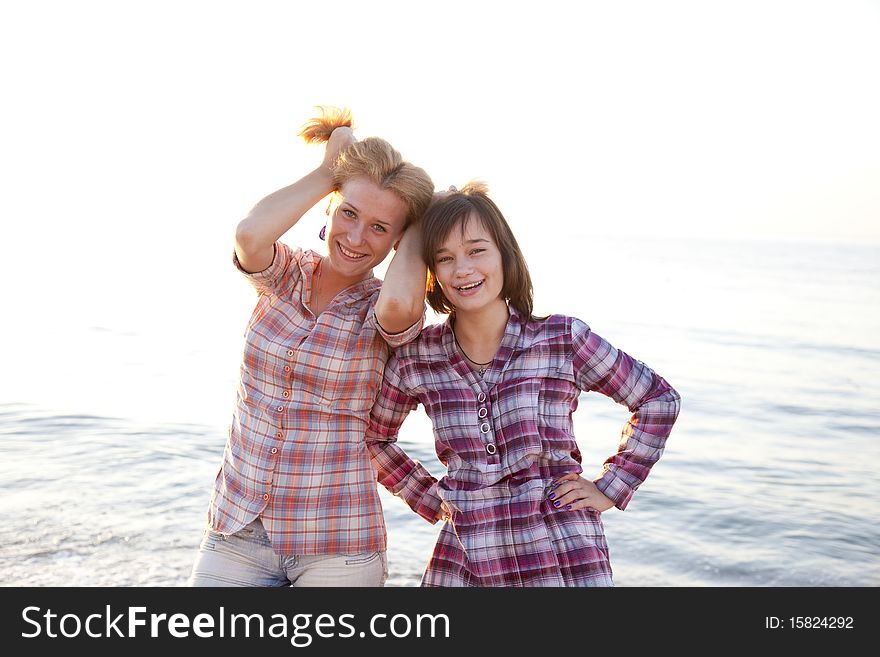 Portrait of two beautiful girls. Outdoor photo.