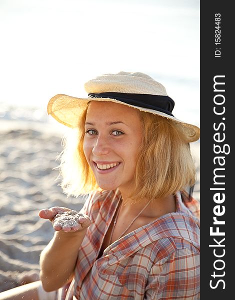 Portrait of beautiful blonde girl in cap. Outdoor photo.