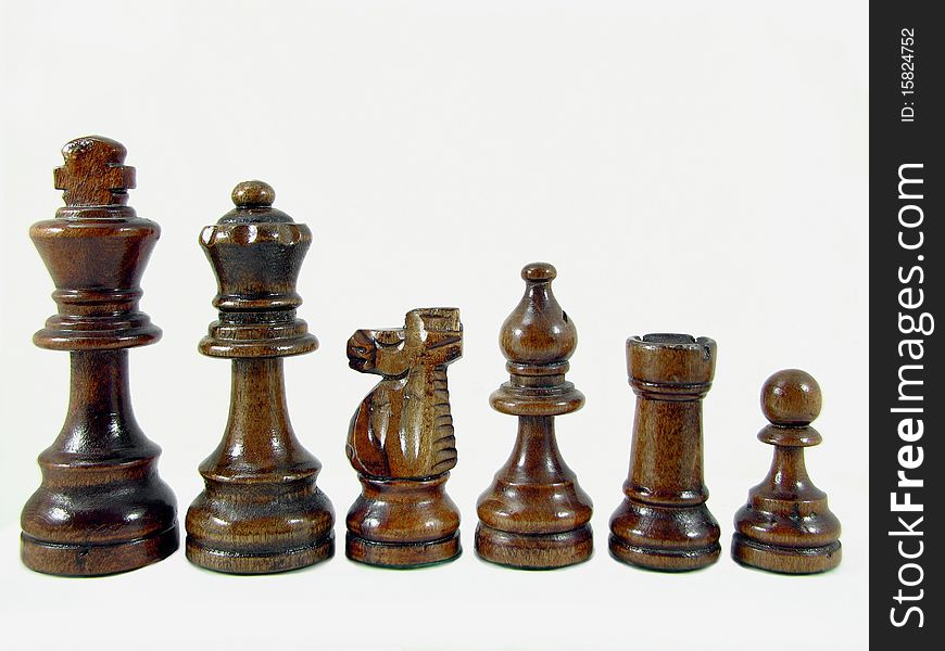 Close up photo of wooden chess pieces, isolated on white background