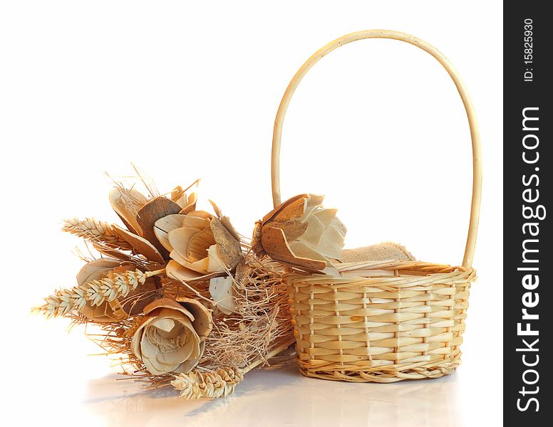 Straw basket and flowers, on white.