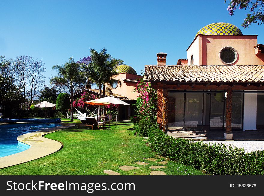 Hotel with swimming pool and palms in the garden. Hotel with swimming pool and palms in the garden