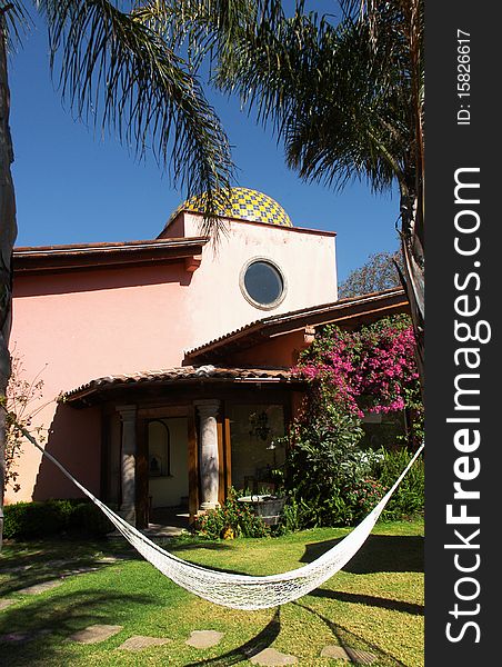 Terrace of hotel with hammock between  the palms