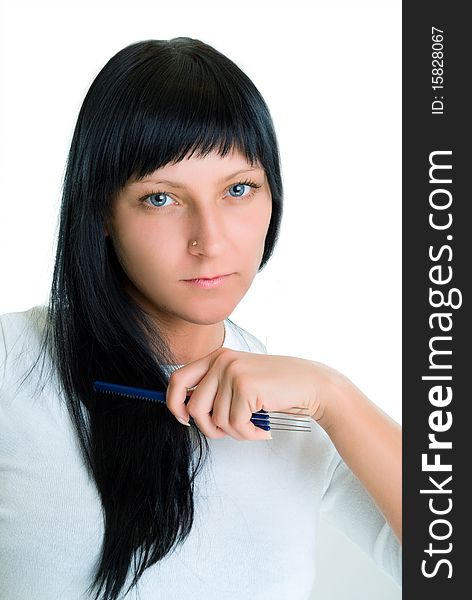 Photo of a girl with blue eyes, which combs hair comb. Isolated on white