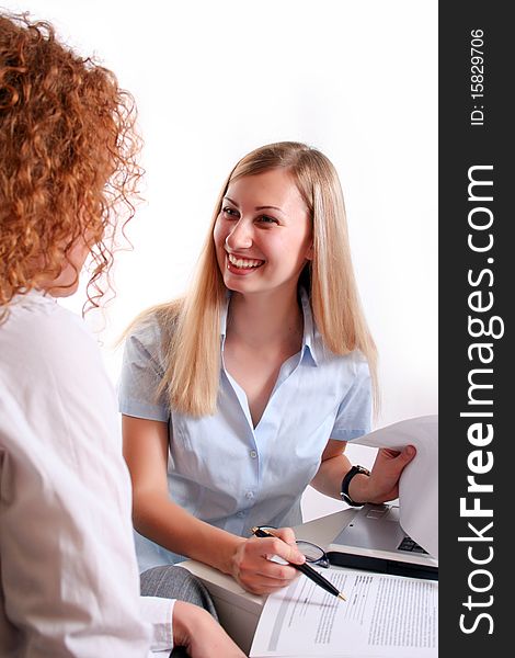 Young smiling business woman working and consulting a partner. Young smiling business woman working and consulting a partner