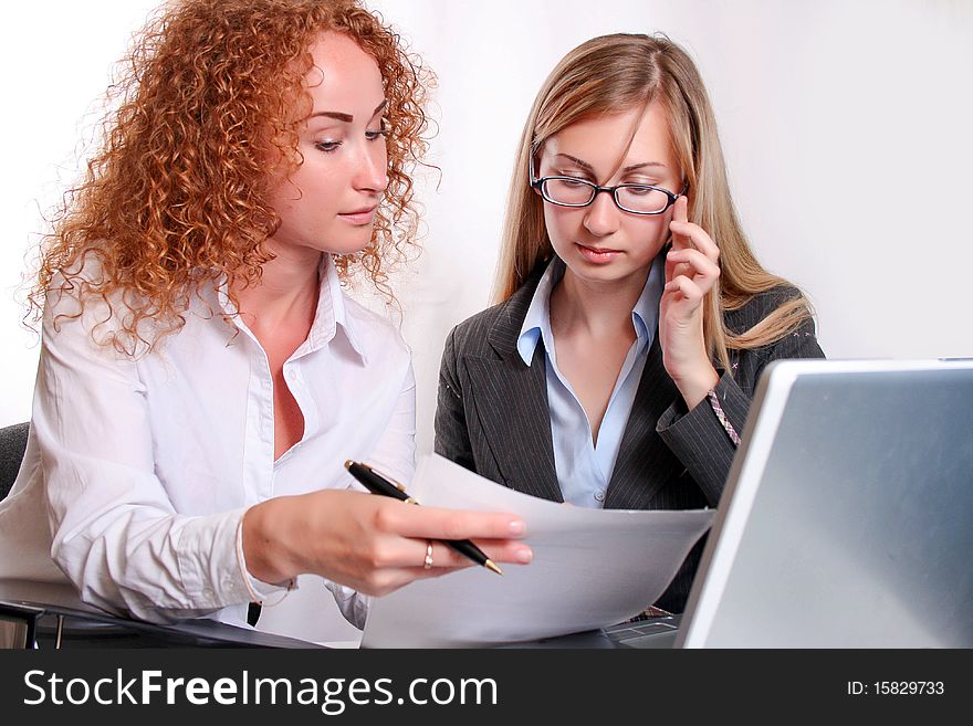 Young smiling business woman working  and consulting a partner. Young smiling business woman working  and consulting a partner