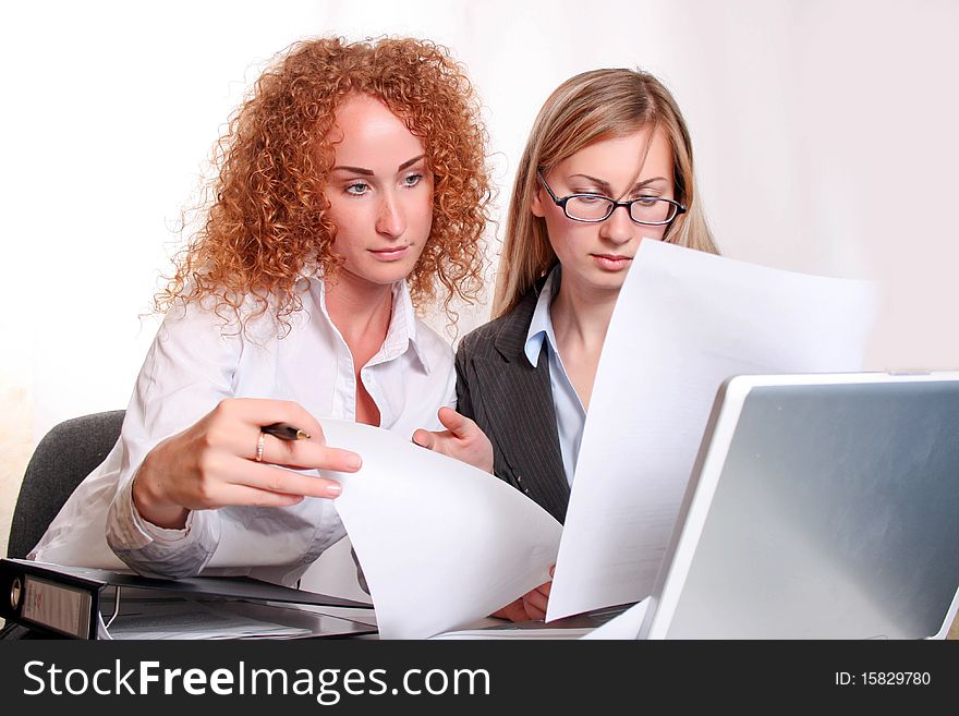 Young smiling business woman working and consulting a partner. Young smiling business woman working and consulting a partner