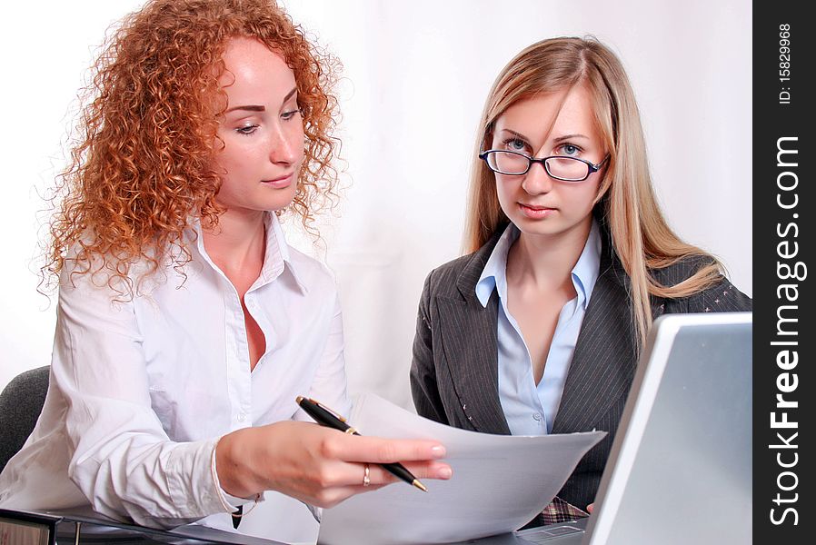 Young smiling business woman working and consulting a partner. Young smiling business woman working and consulting a partner