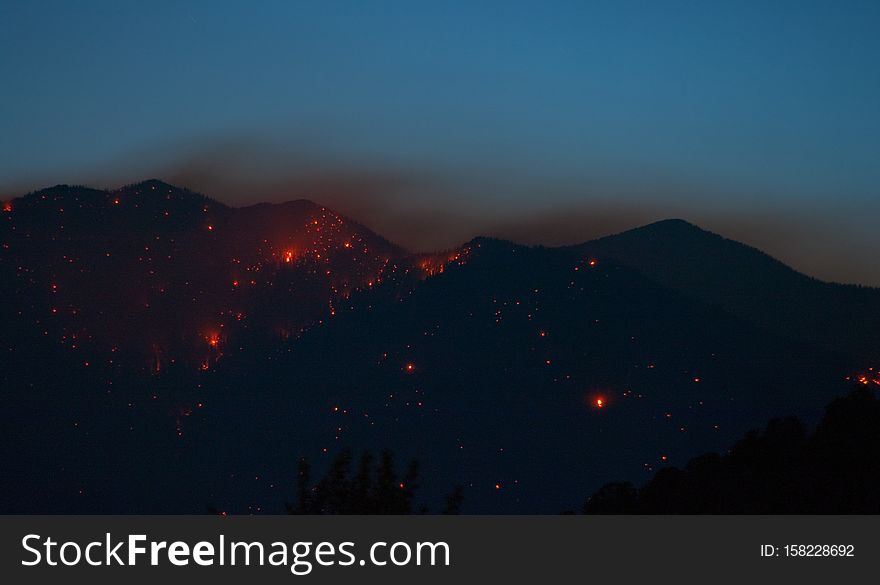 Day 2 of the Schultz Fire, Flagstaff, Arizona. Nighttime shots showing the flames visible on the side of the San Francisco Peaks. The northeastern flank appears to be alight all the way to the top.
