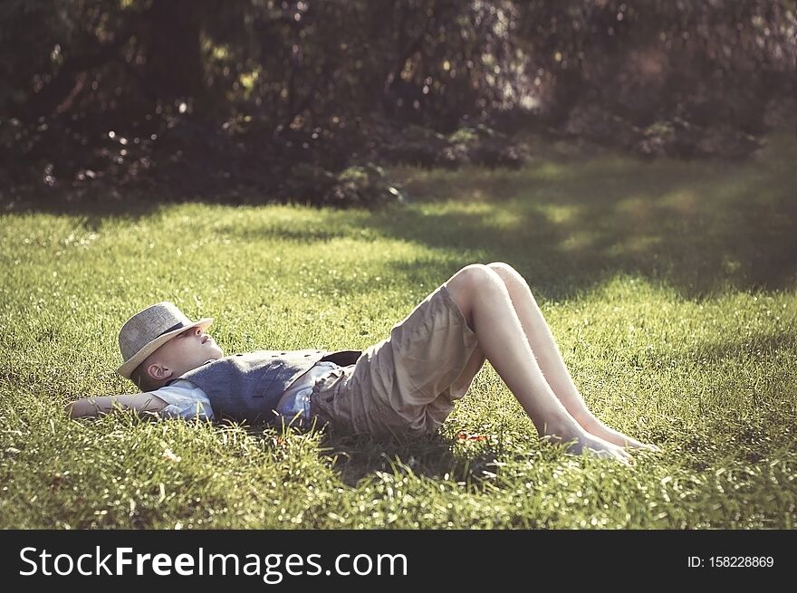 Kid lying on green grass