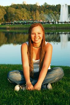 Pretty Girl With Braids Sits On A Grass Stock Photos Pretty Girl With Braids Sits On A Grass Stock Photos