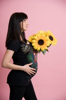 Pregnant Woman Holding Belly With Flowers Stock Photography