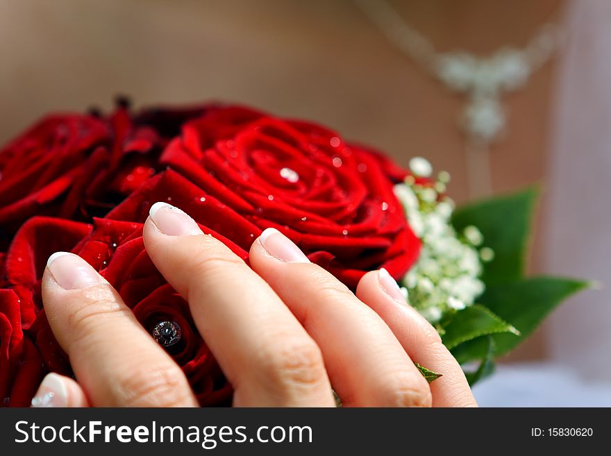 Wedding red flowers bouquet with bride hand. Wedding red flowers bouquet with bride hand