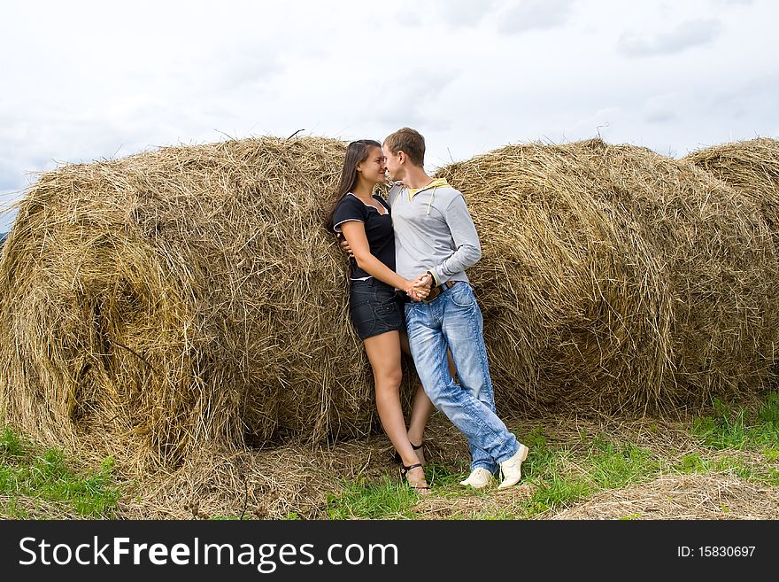 Young couple costs about a haystack