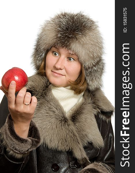 Adorable woman with apple in fur topcoat over white. Adorable woman with apple in fur topcoat over white