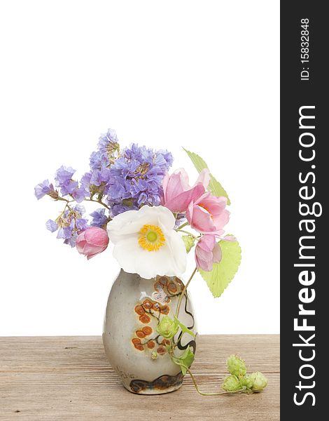 Small flower arrangement in a pottery vase