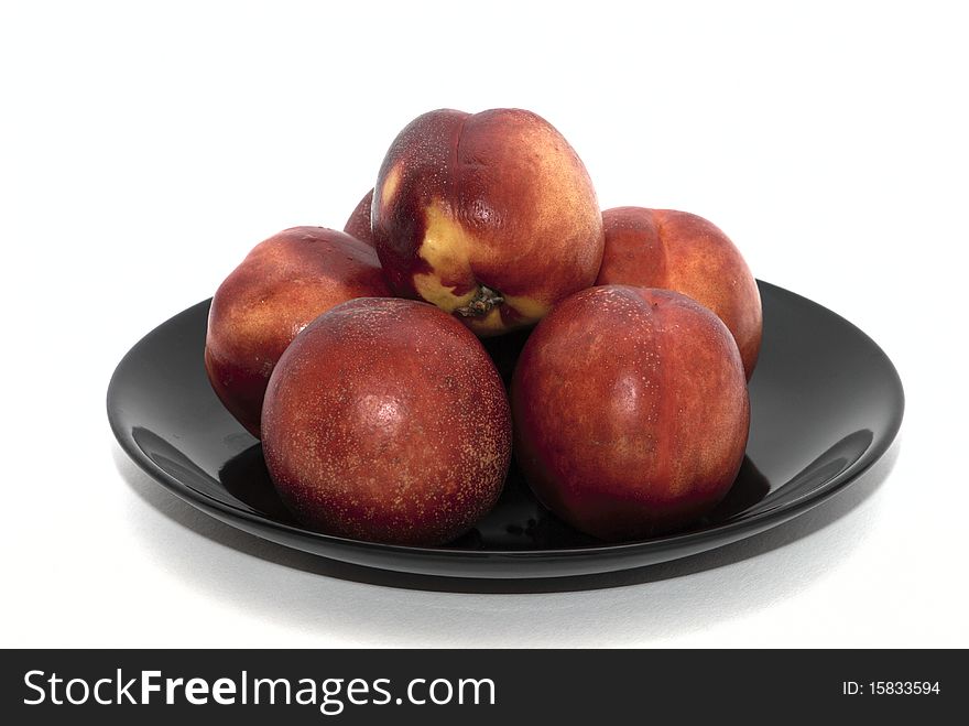 Peaches on the black plate. Peaches on the black plate