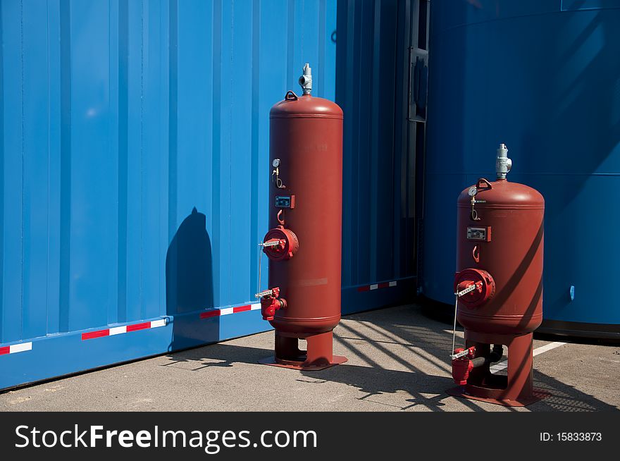 Two gas clinders on industrial parking lot