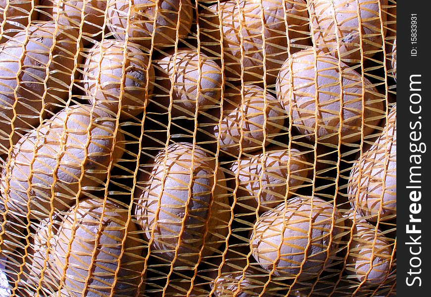 Detail photo texture of the sack of potatoes background