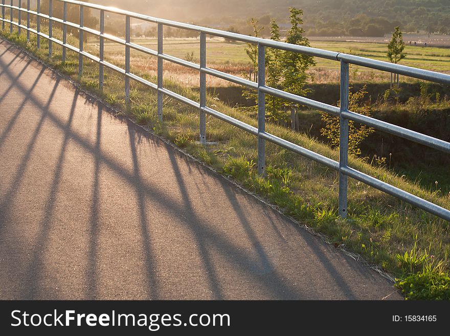 A fence is lighten up by the sun. A fence is lighten up by the sun.