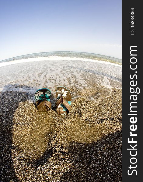 Flip flop on sandy beach in front of the sea. Flip flop on sandy beach in front of the sea