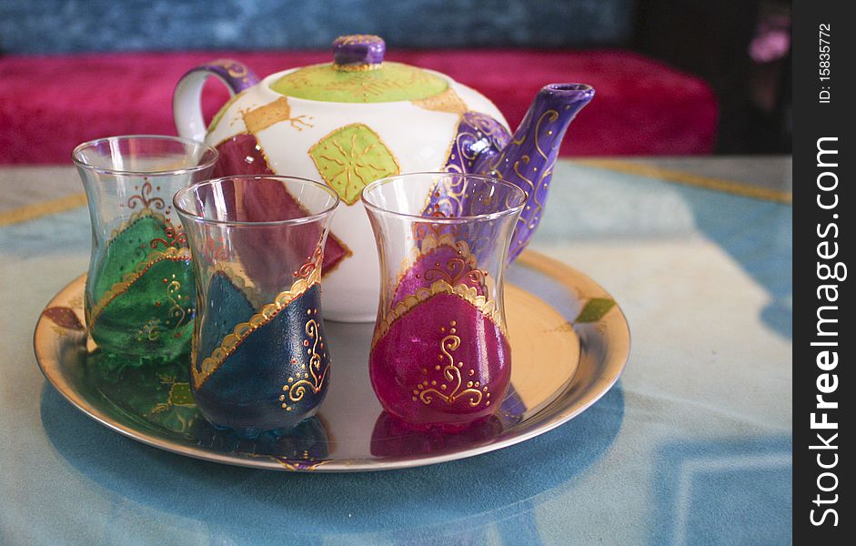 Moroccan teapot and three cups on a tray. Moroccan teapot and three cups on a tray