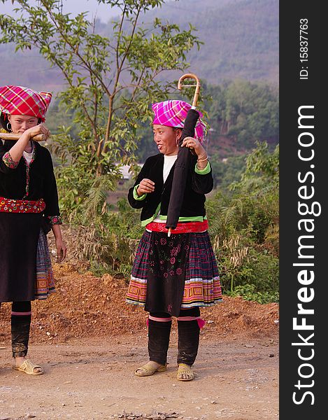 Two young women returning from the fields. Their dress is not folklore they wear daily to work. Two young women returning from the fields. Their dress is not folklore they wear daily to work