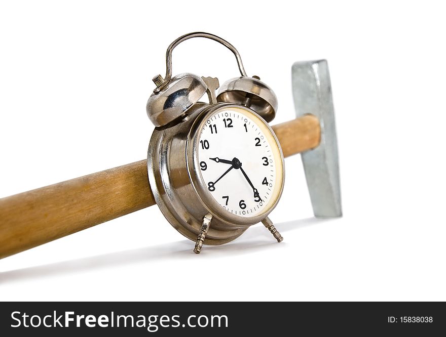Alarm clock and hammer on a white background