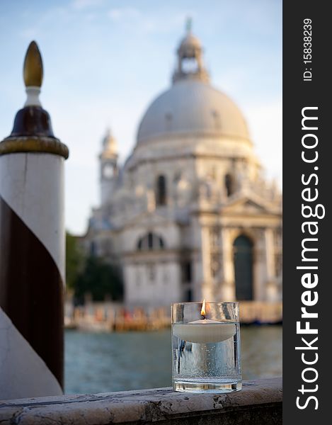 Floating candle with Basilica background  in Venice at dusk. Shallow depth of field